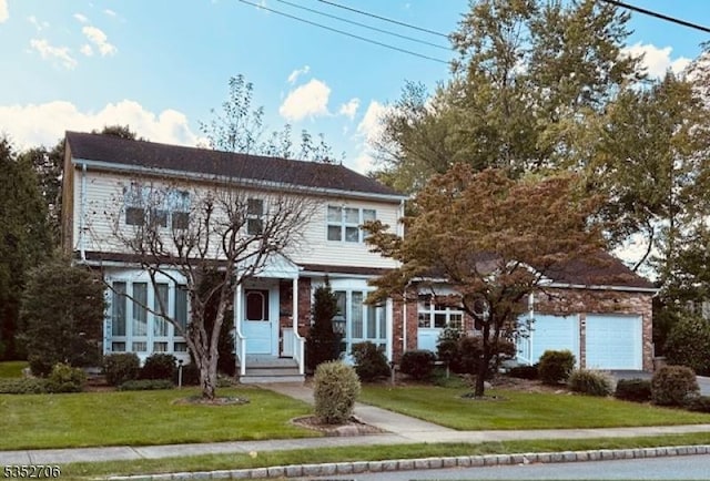 view of front facade featuring a front lawn and a garage