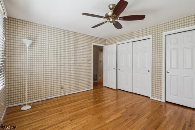 34 Brian Rd, West Caldwell Twp, NJ 07006 - unfurnished bedroom featuring a closet, ceiling fan, wood finished floors, and wallpapered walls