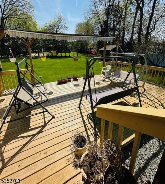 wooden terrace with a yard