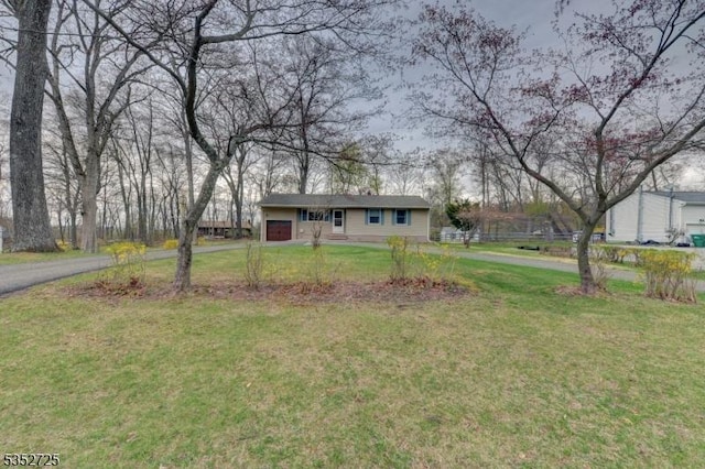 view of front facade featuring a front lawn and aphalt driveway