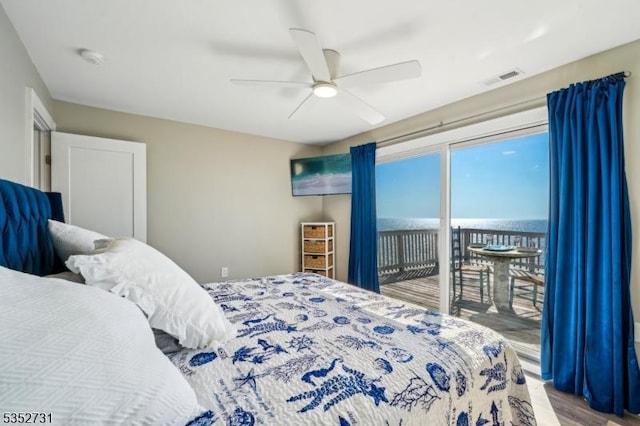 bedroom with ceiling fan, visible vents, access to exterior, and wood finished floors