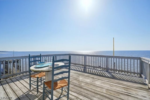wooden terrace featuring a water view