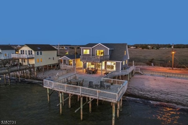 rear view of house featuring a wooden deck and a balcony