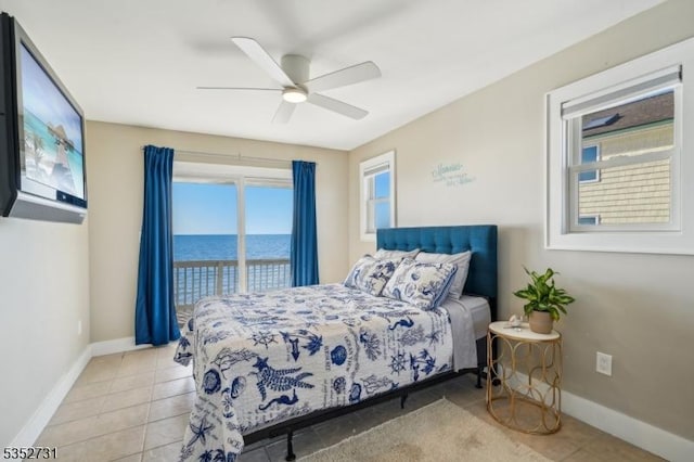 bedroom with light tile patterned floors, a water view, baseboards, and access to exterior