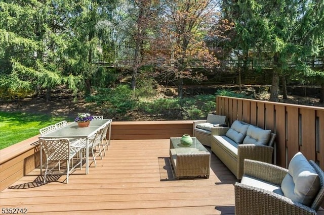 wooden terrace featuring outdoor dining space and an outdoor hangout area