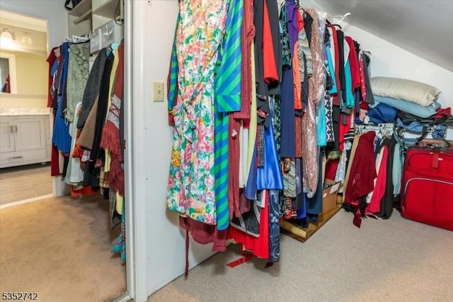 walk in closet featuring carpet flooring