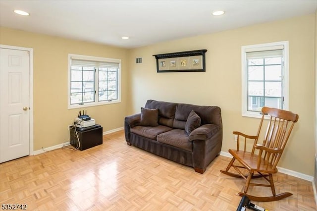 living room with recessed lighting, visible vents, and baseboards