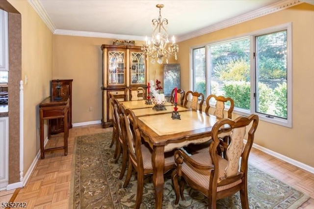 dining space featuring baseboards, ornamental molding, and an inviting chandelier