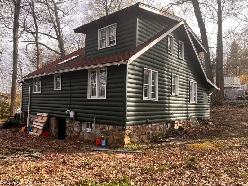 view of side of property featuring log veneer siding