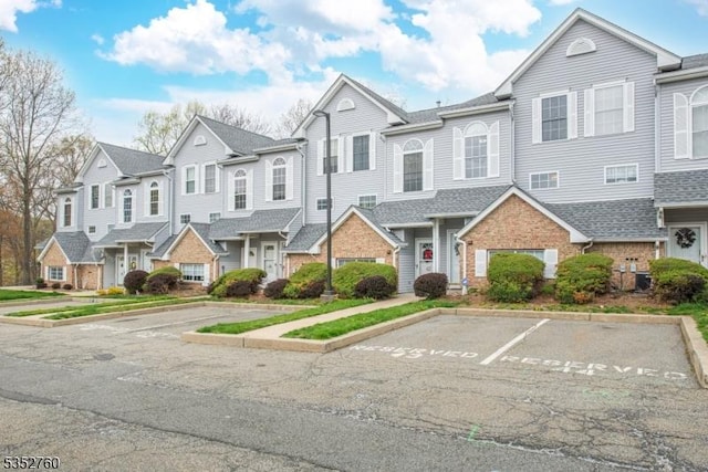 multi unit property with a residential view and uncovered parking