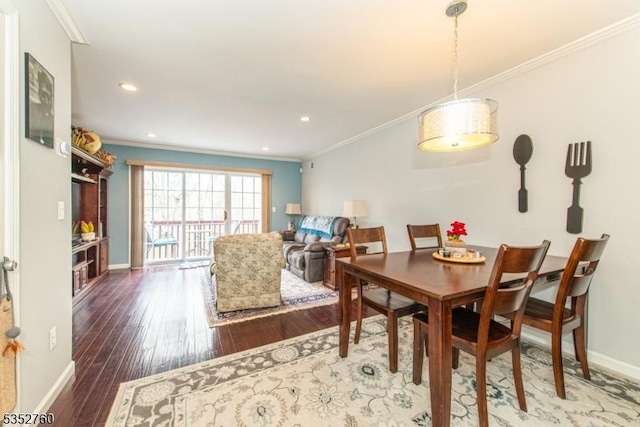 dining space with baseboards, wood-type flooring, and crown molding