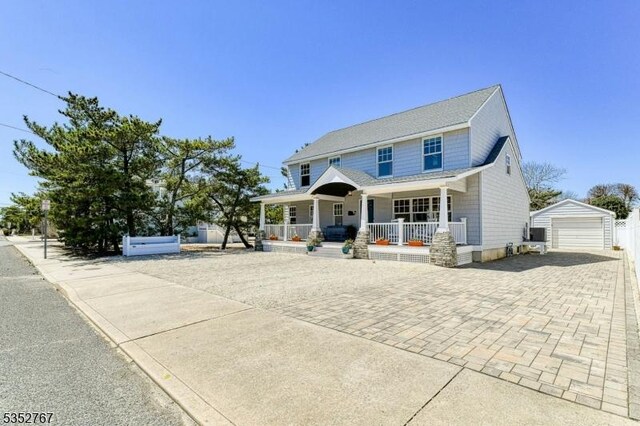 2210 Atlantic Ave, Long Beach Twp, NJ 08008 - view of front of house with a porch, an outdoor structure, decorative driveway, and a detached garage