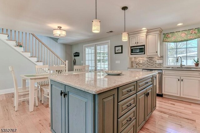 2210 Atlantic Ave, Long Beach Twp, NJ 08008 - kitchen with a sink, appliances with stainless steel finishes, light wood finished floors, and white cabinetry