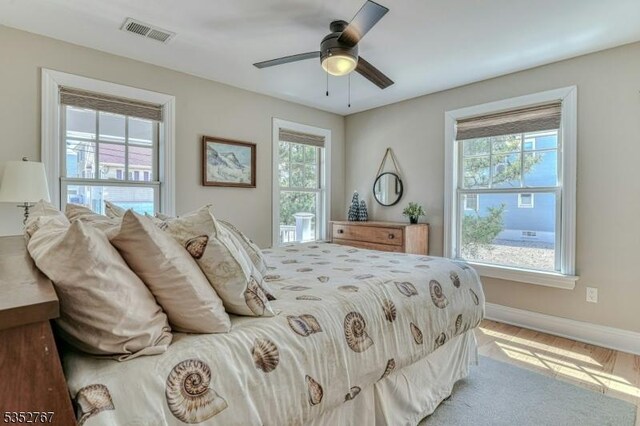 2210 Atlantic Ave, Long Beach Twp, NJ 08008 - bedroom with baseboards, visible vents, multiple windows, and ceiling fan