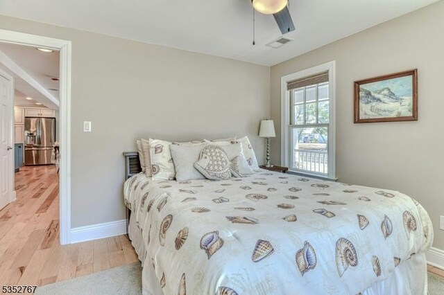 2210 Atlantic Ave, Long Beach Twp, NJ 08008 - bedroom with stainless steel fridge, light wood finished floors, a ceiling fan, baseboards, and visible vents