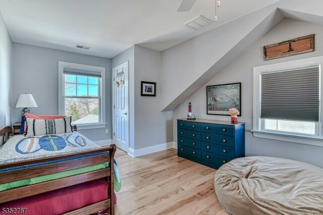 2210 Atlantic Ave, Long Beach Twp, NJ 08008 - bedroom featuring visible vents, ceiling fan, multiple windows, and light wood-type flooring