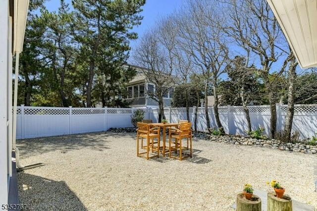 2210 Atlantic Ave, Long Beach Twp, NJ 08008 - view of yard featuring outdoor dining space, a fenced backyard, and a patio area
