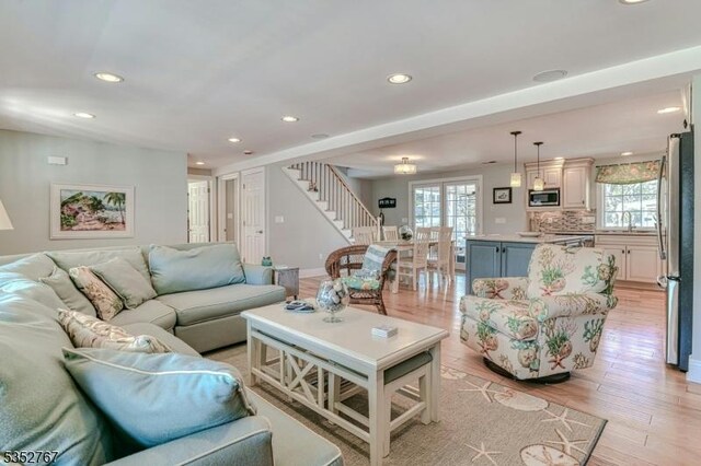 2210 Atlantic Ave, Long Beach Twp, NJ 08008 - living room with recessed lighting, stairs, and a healthy amount of sunlight