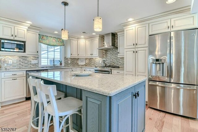 2210 Atlantic Ave, Long Beach Twp, NJ 08008 - kitchen with light wood-style floors, wall chimney exhaust hood, stainless steel appliances, tasteful backsplash, and a kitchen island