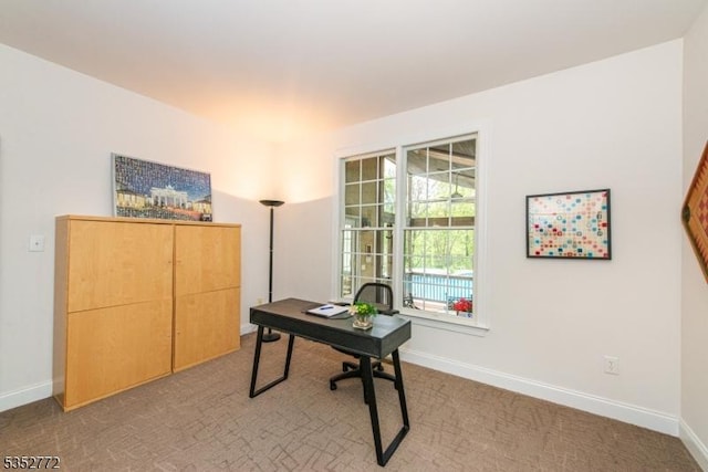 office with baseboards and carpet flooring
