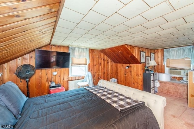 carpeted bedroom featuring cooling unit, vaulted ceiling, and wood walls