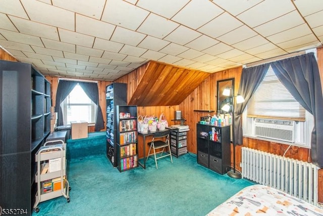interior space featuring wood walls, radiator heating unit, vaulted ceiling, and cooling unit