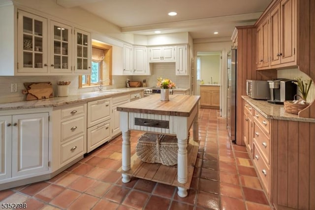 199 W Springtown Rd, Washington Twp, NJ 07853 - kitchen featuring butcher block counters, tasteful backsplash, a sink, glass insert cabinets, and recessed lighting