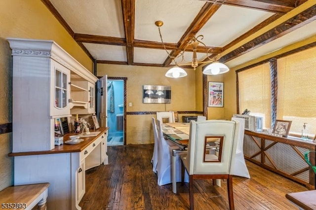 dining space with beam ceiling, coffered ceiling, and dark wood-style floors