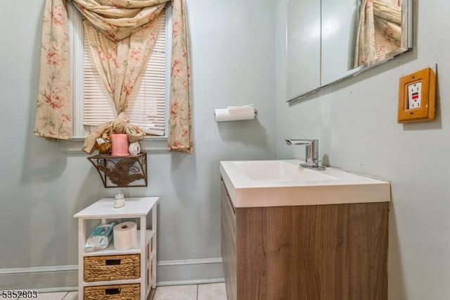 bathroom with tile patterned floors, vanity, and baseboards