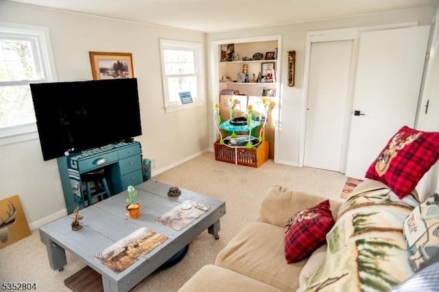 living room with baseboards and carpet