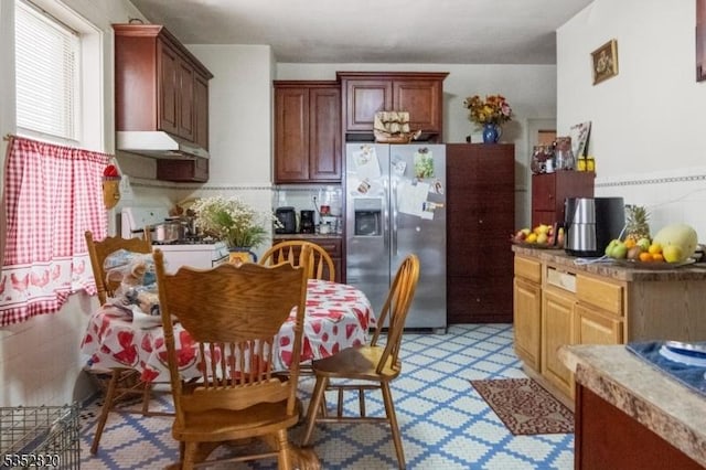 222 Van Buren St, Newark City, NJ 07105 - kitchen featuring stainless steel fridge, white range with gas cooktop, under cabinet range hood, and tasteful backsplash