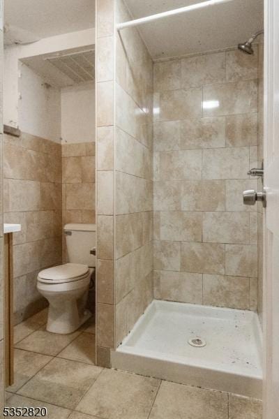 222 Van Buren St, Newark City, NJ 07105 - full bathroom featuring tile patterned floors, a shower stall, toilet, and tile walls