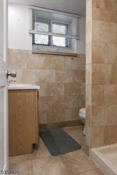 222 Van Buren St, Newark City, NJ 07105 - full bathroom with tile patterned floors, a shower stall, toilet, and tile walls