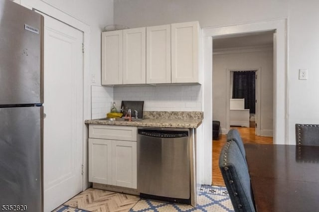 222 Van Buren St, Newark City, NJ 07105 - kitchen featuring decorative backsplash, a sink, light countertops, white cabinets, and stainless steel appliances