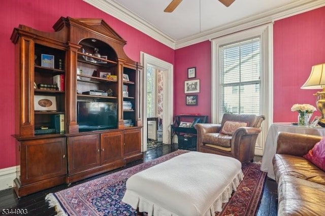 interior space with a ceiling fan, ornamental molding, and wood finished floors