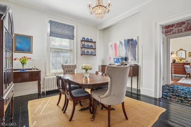 dining room with a notable chandelier, ornamental molding, dark wood-style flooring, and radiator heating unit