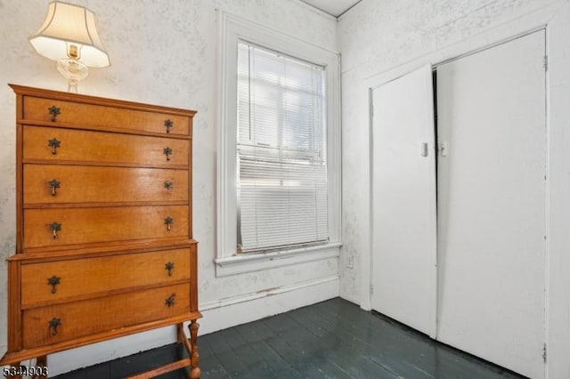 bedroom featuring a closet and dark wood-style flooring