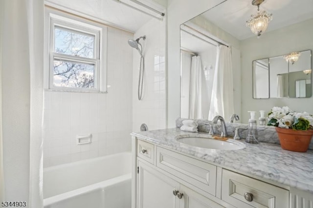 bathroom featuring shower / bath combination with curtain and vanity