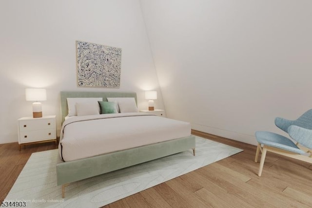 bedroom featuring baseboards and wood finished floors