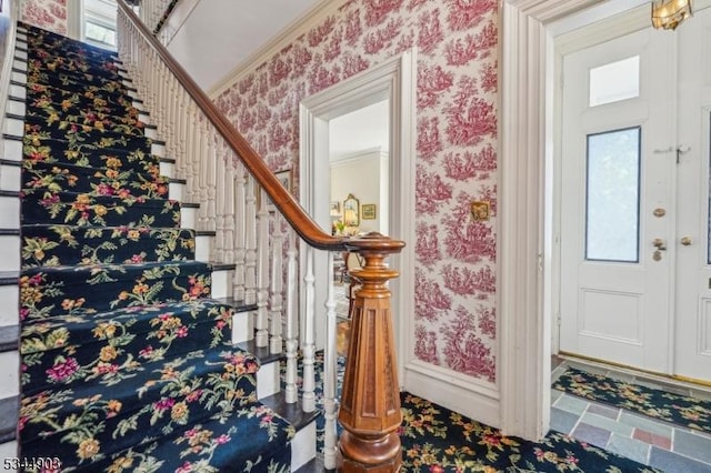 interior space with wallpapered walls, baseboards, and stairs