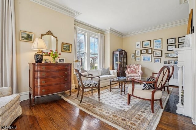 sitting room with dark wood-style floors and ornamental molding