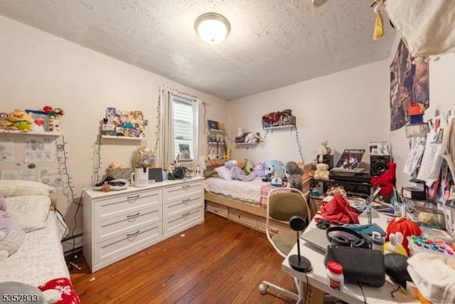 76 Kossuth St, Newark City, NJ 07105 - bedroom featuring a textured ceiling, hardwood / wood-style flooring, and a baseboard radiator