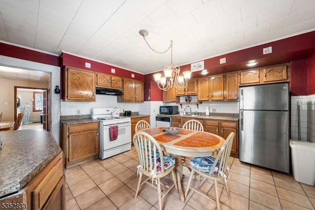 76 Kossuth St, Newark City, NJ 07105 - kitchen featuring white appliances, under cabinet range hood, a chandelier, and light tile patterned flooring