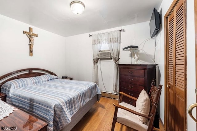 76 Kossuth St, Newark City, NJ 07105 - bedroom featuring wood finished floors, a baseboard radiator, a closet, and cooling unit