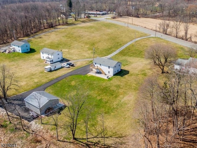 drone / aerial view with a wooded view and a rural view