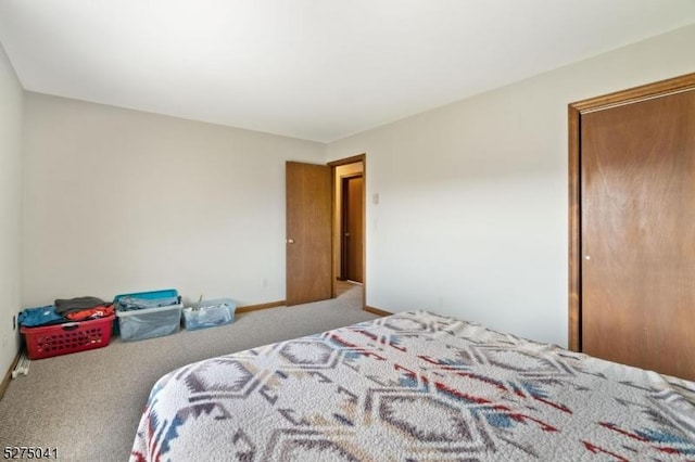 bedroom with carpet floors and baseboards