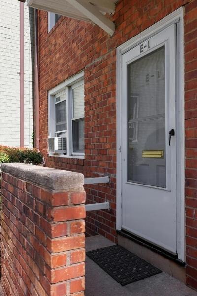 property entrance featuring brick siding