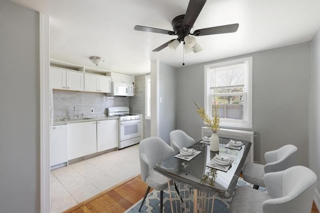 dining space featuring light wood-style floors and a ceiling fan