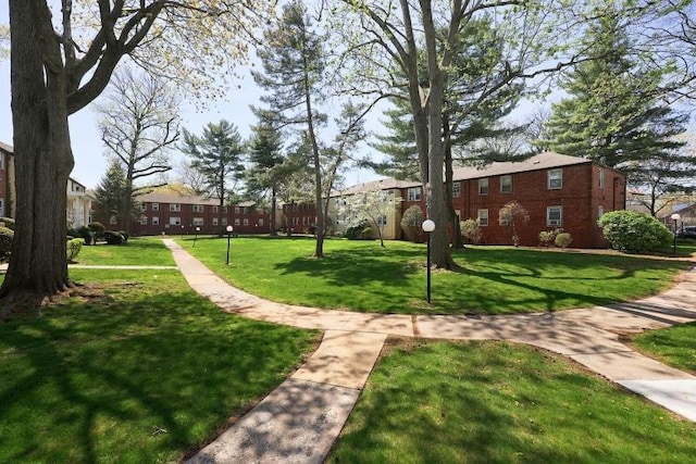 surrounding community featuring a lawn and a residential view