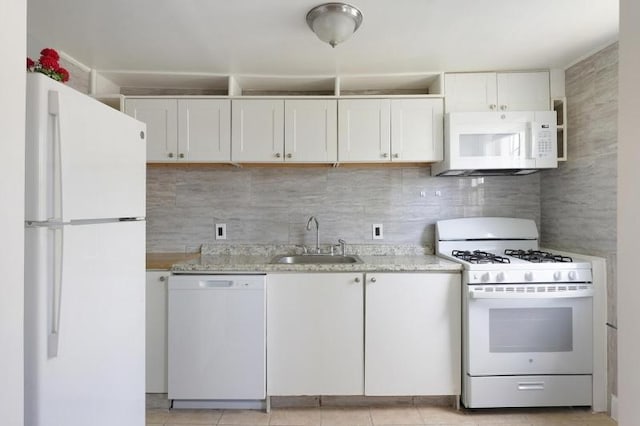 kitchen featuring a sink, white cabinets, backsplash, and white appliances